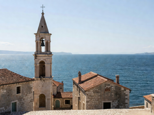 Ancient Venetian stone architecture and bell tower overlooking Adriatic waters in Montenegro