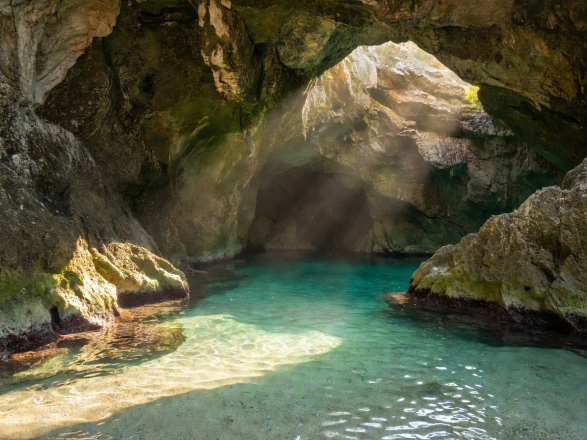 Sunlight beaming into secret sea caves of Lustica Peninsula Montenegro