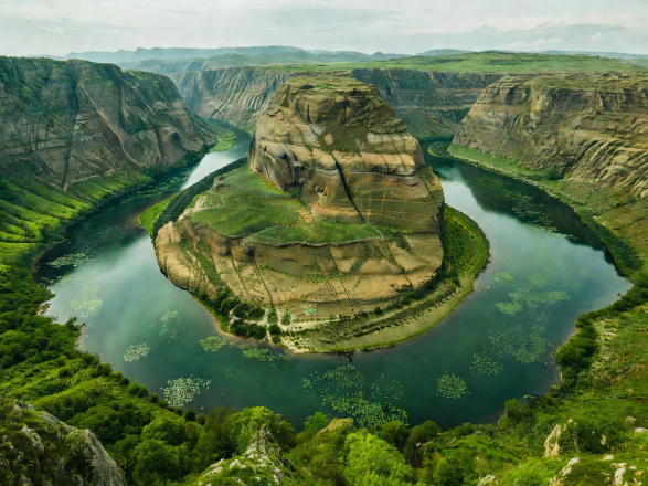 Winding horseshoe bend of Rijeka Crnojevica and Lake Skadar Montenegro with lily pads